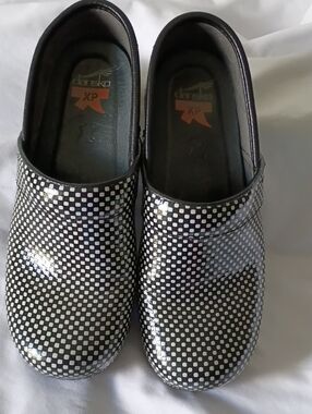 Dansko Black & White Checkered Patent Clogs